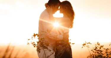 Couple Standing Beside Plants during Golden Hour