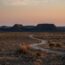 A dirt road in the middle of a desert