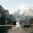 A bride and groom are standing on a dock